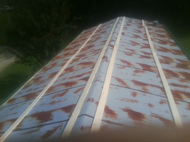Rusted metal roof panels with new wood purlins before replacement — Storm Damage Roof Repair in Marlin by Roofing Brothers